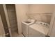 Bright laundry room with washer, dryer, and shelving providing ample storage space at 5609 Sweet River Dr, Indianapolis, IN 46221