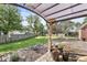 Backyard patio with shade structure, stone patio, and landscaped garden, ideal for outdoor entertaining and relaxation at 5747 Allisonville Rd, Indianapolis, IN 46220