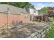 Backyard area with brick patio, rock wall, and stone landscaping offering a tranquil space for outdoor living at 5747 Allisonville Rd, Indianapolis, IN 46220