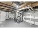 Unfinished basement with exposed ductwork, utility equipment and concrete block walls, ready to be renovated at 5747 Allisonville Rd, Indianapolis, IN 46220