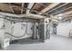 Unfinished basement utility area with water heater, furnace, and gray painted floors offering storage or potential at 5747 Allisonville Rd, Indianapolis, IN 46220