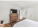 Bedroom showcasing wood floors, dresser and ample natural light at 5747 Allisonville Rd, Indianapolis, IN 46220