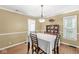 Dining room with a large window and a classic chandelier at 5747 Allisonville Rd, Indianapolis, IN 46220