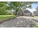 Brick home with a two-car garage and a large driveway at 5747 Allisonville Rd, Indianapolis, IN 46220
