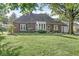 Quaint brick home featuring a manicured front lawn and welcoming entrance at 5747 Allisonville Rd, Indianapolis, IN 46220
