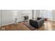 Cozy living room with a decorative fireplace, hardwood floors, and natural light at 5747 Allisonville Rd, Indianapolis, IN 46220