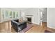 Inviting living room with hardwood floors, fireplace, and large windows at 5747 Allisonville Rd, Indianapolis, IN 46220