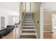 Interior view featuring a classic wooden staircase and hardwood floors at 5747 Allisonville Rd, Indianapolis, IN 46220