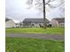 Spacious backyard with a large green lawn, a trampoline, and a wooden deck that is great for outdoor activities at 5848 Jackie Ln, Indianapolis, IN 46221