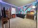 Stylish bedroom features vibrant geometric wall design, ample natural light, and contemporary decor at 5848 Jackie Ln, Indianapolis, IN 46221