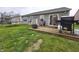 Wooden deck with a grill, fire pit, and chairs providing a great space for outdoor dining and entertaining at 5848 Jackie Ln, Indianapolis, IN 46221
