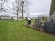 Cozy wooden deck featuring a grill, dining set, and lush lawn, perfect for relaxation and outdoor enjoyment at 5848 Jackie Ln, Indianapolis, IN 46221