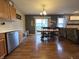 Dining area and living space with wood floors and sliding doors to the backyard at 5848 Jackie Ln, Indianapolis, IN 46221