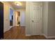 Inviting hallway with wood flooring, neutral walls, and access to several rooms at 5848 Jackie Ln, Indianapolis, IN 46221