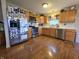 Bright kitchen showcases wood cabinets, stainless steel appliances, and a durable wood floor at 5848 Jackie Ln, Indianapolis, IN 46221
