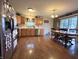 Well-lit kitchen featuring wood floors, stainless steel appliances, and adjacent dining area at 5848 Jackie Ln, Indianapolis, IN 46221