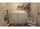 Functional laundry room with washer, dryer, and storage for efficient chores at 5848 Jackie Ln, Indianapolis, IN 46221