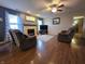 Well-lit living room with hardwood floors, fireplace, and comfortable seating at 5848 Jackie Ln, Indianapolis, IN 46221