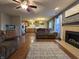 Comfortable living room featuring a fireplace, wood flooring, and adjacent kitchen area at 5848 Jackie Ln, Indianapolis, IN 46221