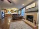 Inviting living room with fireplace, wood floors, and an open layout at 5848 Jackie Ln, Indianapolis, IN 46221