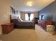 Comfortable main bedroom with wood furniture and neutral tones, creating a serene space at 5848 Jackie Ln, Indianapolis, IN 46221