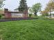 Well-manicured Crossfield community entrance with lush landscaping and brick signage at 5848 Jackie Ln, Indianapolis, IN 46221