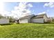 A spacious backyard featuring a well-maintained lawn, wood box, and a charming single-story home at 5855 La Fleur Ct, Indianapolis, IN 46237
