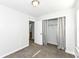 This bedroom features neutral carpet, an open closet with gray curtains, and a view into an adjoining bathroom at 5855 La Fleur Ct, Indianapolis, IN 46237