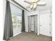 This bedroom features carpet flooring, curtains, a ceiling fan and an open closet at 5855 La Fleur Ct, Indianapolis, IN 46237