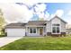 Charming one-story home boasts an attached garage, manicured lawn, and inviting curb appeal at 5855 La Fleur Ct, Indianapolis, IN 46237