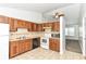 Cozy kitchen featuring oak cabinets, tile backsplash, white appliances, and a tile floor at 5855 La Fleur Ct, Indianapolis, IN 46237