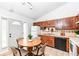 Eat-in kitchen features wood cabinets, tile backsplash and flooring, and a neutral color scheme at 5855 La Fleur Ct, Indianapolis, IN 46237