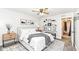 A staged primary bedroom showcases neutral colors and floating shelves for added decor at 5855 La Fleur Ct, Indianapolis, IN 46237