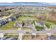 Aerial view of a residential community with homes surrounding scenic ponds and green spaces at 6044 Shallow Crk Ln, Indianapolis, IN 46237