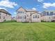 Expansive backyard featuring a well-maintained lawn and a home with large windows at 6044 Shallow Crk Ln, Indianapolis, IN 46237