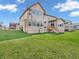 Expansive backyard featuring a large, well-maintained lawn with a home with a deck, and large windows at 6044 Shallow Crk Ln, Indianapolis, IN 46237