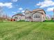 Spacious backyard with green lawn, showcasing the home's rear exterior and neighborhood at 6044 Shallow Crk Ln, Indianapolis, IN 46237