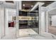 Luxurious bathroom featuring a glass shower with black marble accents and gold hardware, with a large closet on the side at 6044 Shallow Crk Ln, Indianapolis, IN 46237
