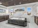 Luxurious bathroom featuring marble walls, dual vanities, and a striking black and gold soaking tub at 6044 Shallow Crk Ln, Indianapolis, IN 46237