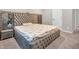 Bedroom featuring a platform bed with decorative mirror accents and a plush, tufted headboard at 6044 Shallow Crk Ln, Indianapolis, IN 46237