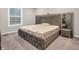 Well-lit bedroom with a stylish platform bed, mirrored nightstand, and modern decor at 6044 Shallow Crk Ln, Indianapolis, IN 46237