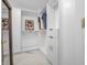 Spacious walk-in closet with custom white shelving and cabinets with gold hardware and marble floor at 6044 Shallow Crk Ln, Indianapolis, IN 46237
