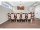 Formal dining room featuring hardwood floors, a large dining table with upholstered chairs and elegant decor at 6044 Shallow Crk Ln, Indianapolis, IN 46237