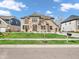 Charming two-story brick home with a well-manicured lawn, complemented by a sunny sky and verdant landscaping at 6044 Shallow Crk Ln, Indianapolis, IN 46237