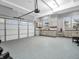 Spacious garage with epoxy floors, custom cabinets, sink, and natural light at 6044 Shallow Crk Ln, Indianapolis, IN 46237