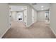 Bright, open hallway with neutral tones and multiple doorways, creating a welcoming and spacious atmosphere at 6044 Shallow Crk Ln, Indianapolis, IN 46237