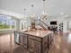 Well-appointed kitchen island with sink, seating, and modern pendant lighting at 6044 Shallow Crk Ln, Indianapolis, IN 46237