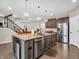 Kitchen island with seating, sink, dishwasher, and stainless steel appliances at 6044 Shallow Crk Ln, Indianapolis, IN 46237