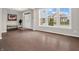Open-concept living area with hardwood floors, large windows, a front door and plenty of natural light at 6044 Shallow Crk Ln, Indianapolis, IN 46237