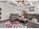Living room featuring oversized leather sofas, a decorative rug, and an open view to the foyer at 6044 Shallow Crk Ln, Indianapolis, IN 46237